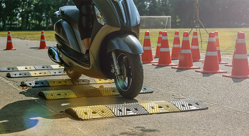 learner moped riding over speed bumps.webp
